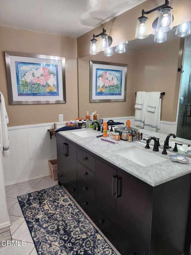 bathroom with vanity, an enclosed shower, tile patterned flooring, and a textured ceiling