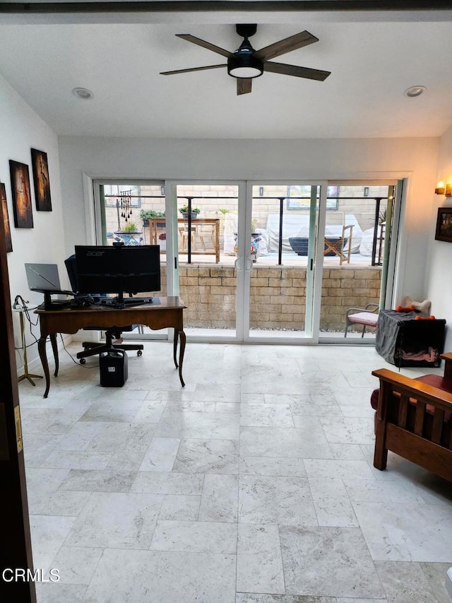 home office with plenty of natural light and ceiling fan