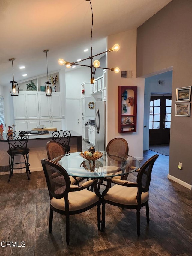 dining room featuring french doors, dark hardwood / wood-style floors, and vaulted ceiling