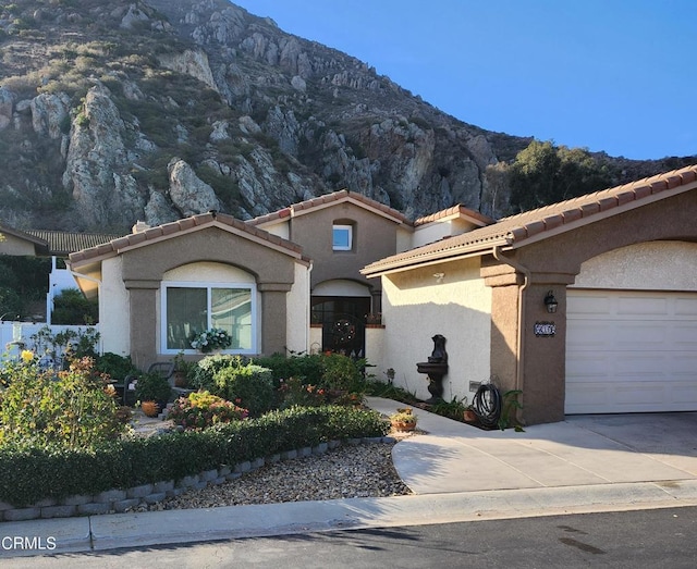 view of front of home featuring a mountain view and a garage