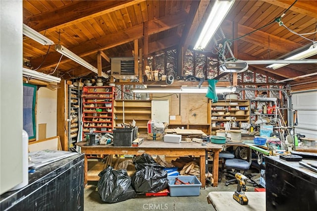 misc room with lofted ceiling with beams, concrete floors, and a workshop area