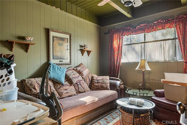 living room featuring wooden walls and ceiling fan