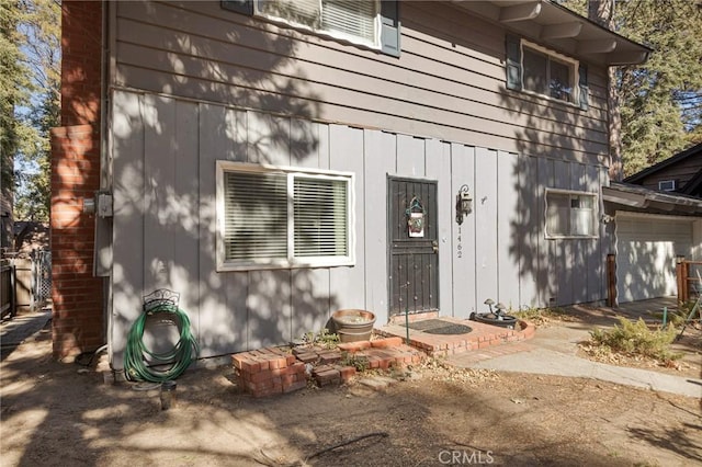 doorway to property with a garage