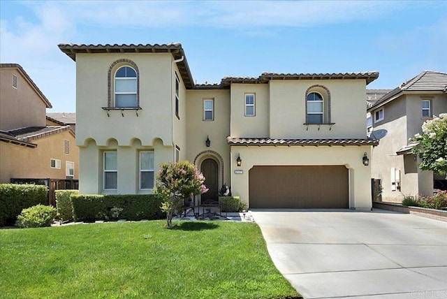 mediterranean / spanish-style home with an attached garage, a front yard, concrete driveway, and stucco siding