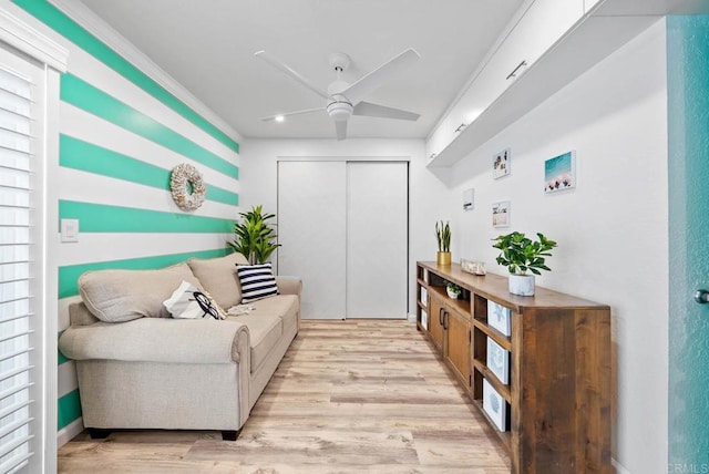 interior space featuring crown molding, plenty of natural light, ceiling fan, and light hardwood / wood-style flooring