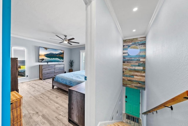 bedroom with ornamental molding, ceiling fan, and light hardwood / wood-style floors