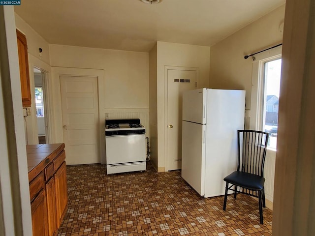 kitchen featuring white appliances and tile countertops