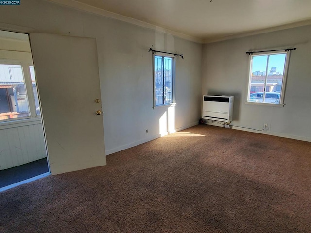 unfurnished living room with ornamental molding, carpet, and heating unit