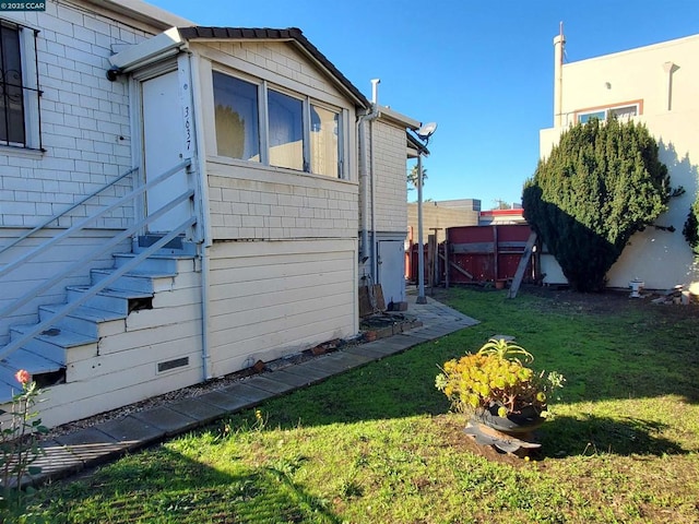 view of side of property with a yard