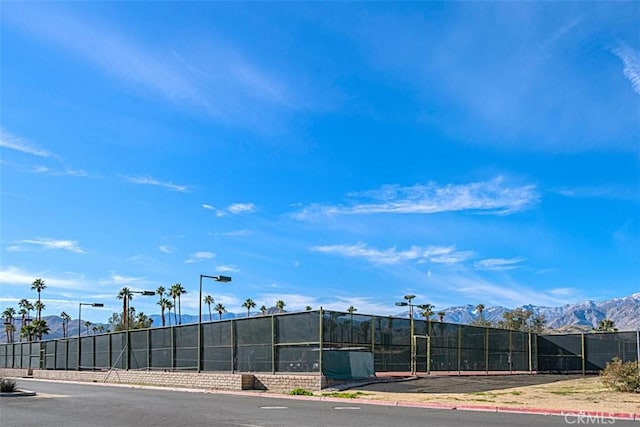 exterior space with fence and a mountain view