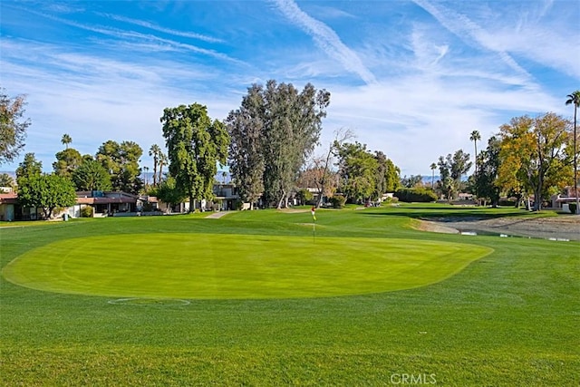 view of home's community with a lawn and golf course view