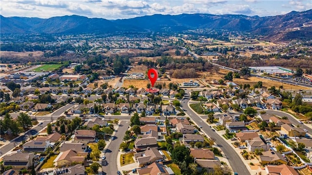 birds eye view of property featuring a mountain view