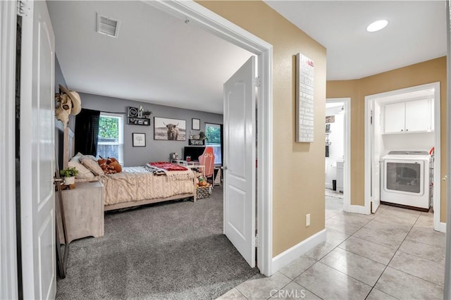 tiled bedroom featuring washer / dryer