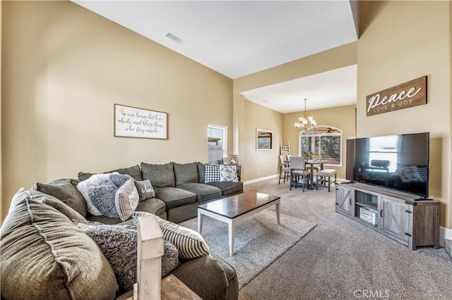 living room featuring an inviting chandelier, carpet floors, and a healthy amount of sunlight