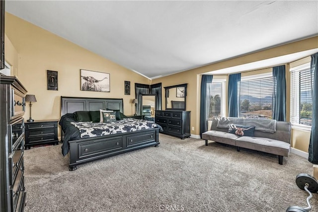 bedroom with vaulted ceiling and light carpet