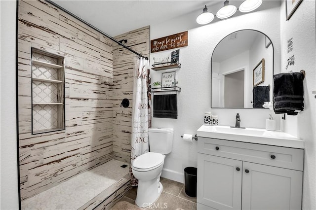 bathroom featuring tile patterned flooring, vanity, toilet, and a shower with shower curtain