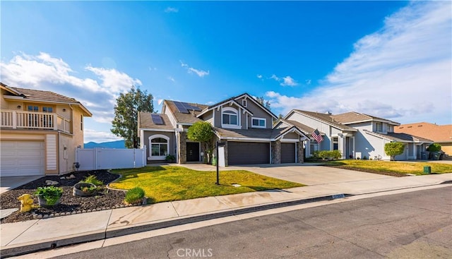 front of property featuring a garage, a front yard, and solar panels