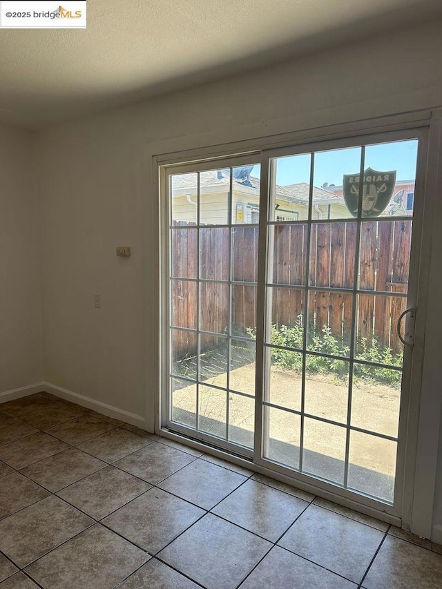 doorway with tile patterned flooring