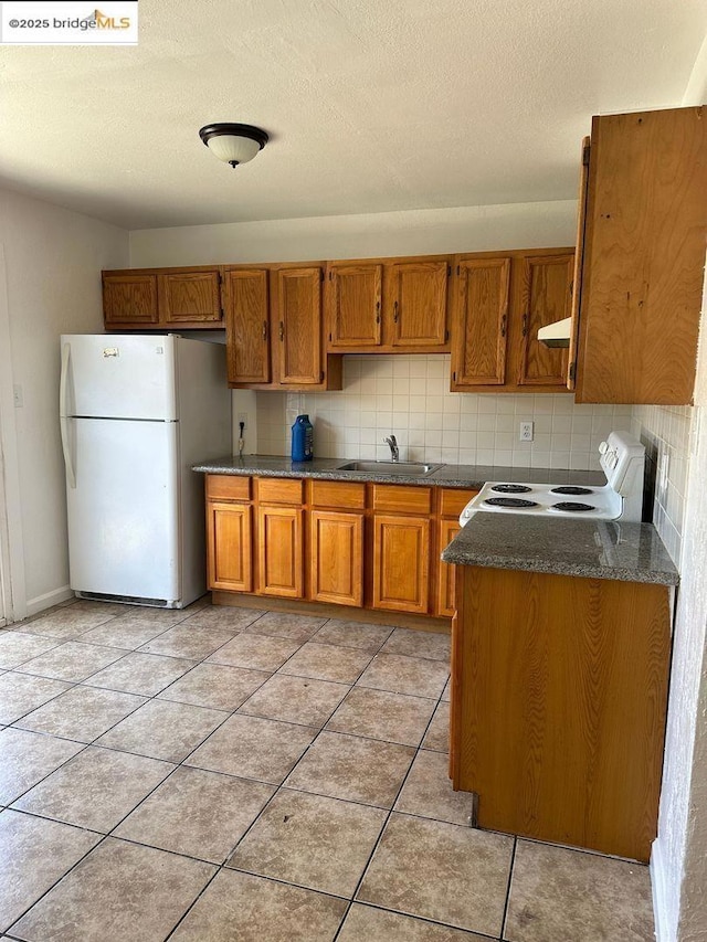 kitchen with sink, white appliances, backsplash, and extractor fan