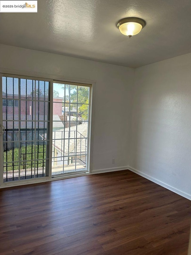 empty room featuring dark hardwood / wood-style floors