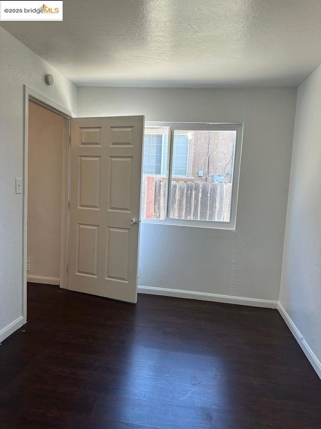 unfurnished room featuring dark hardwood / wood-style floors