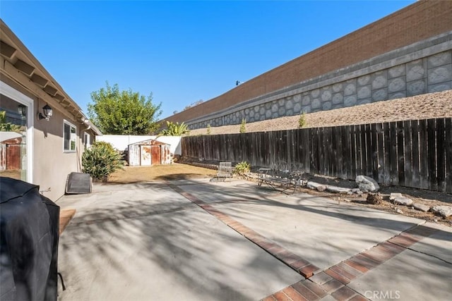 view of patio / terrace featuring area for grilling and a storage shed