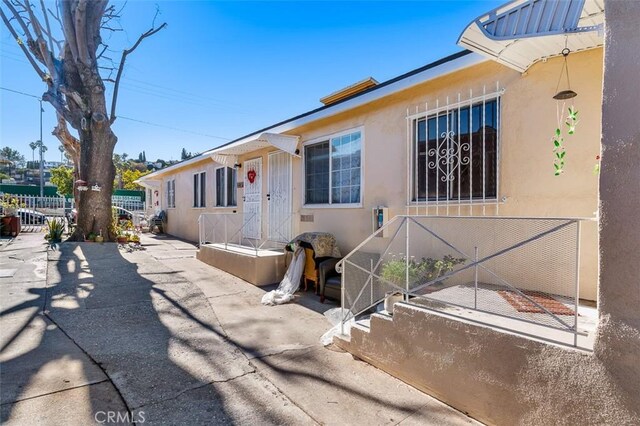 4665 Huntington Dr N, Los Angeles, CA 90032 - view of side of property with fence and stucco siding
