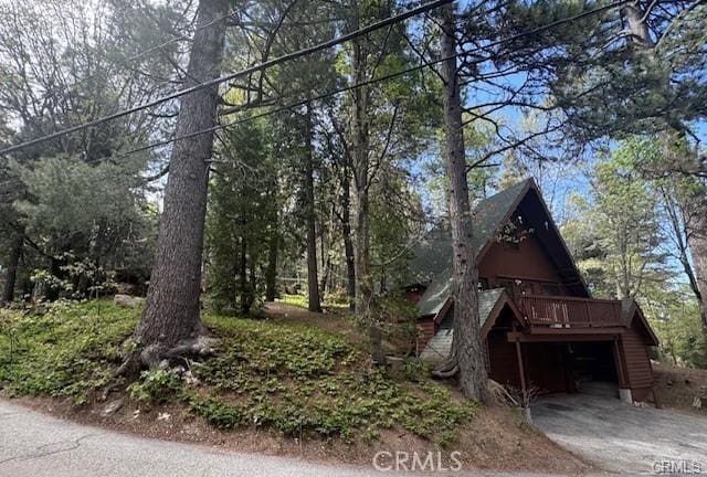 view of property exterior with a wooden deck