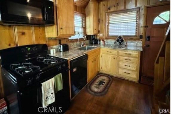 kitchen featuring sink, dark hardwood / wood-style floors, and black appliances