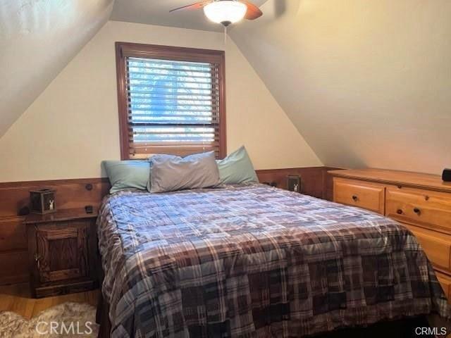 bedroom featuring ceiling fan, vaulted ceiling, and hardwood / wood-style floors