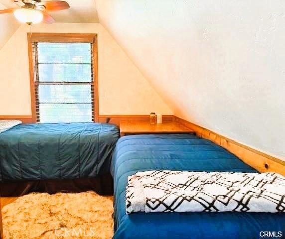 bedroom with ceiling fan and vaulted ceiling