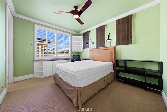 carpeted bedroom featuring crown molding and ceiling fan