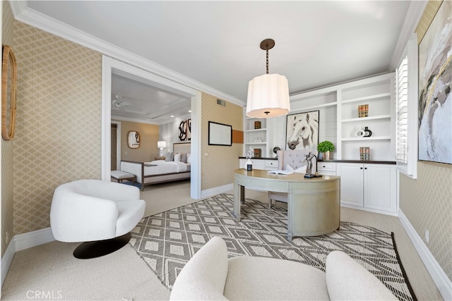 office featuring crown molding, light colored carpet, and built in shelves