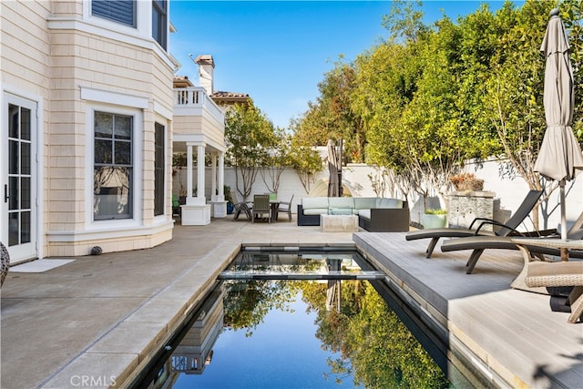 view of swimming pool with an outdoor living space and a patio