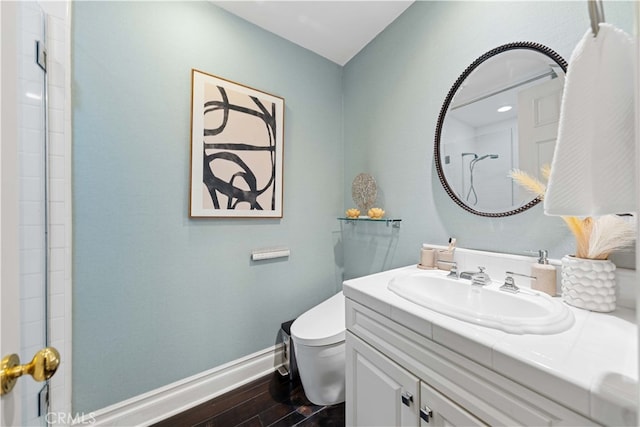 bathroom featuring vanity, hardwood / wood-style flooring, and toilet