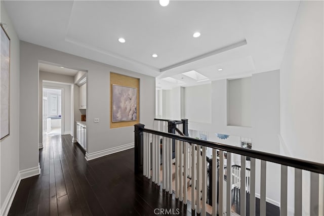 hall featuring dark hardwood / wood-style floors and a raised ceiling