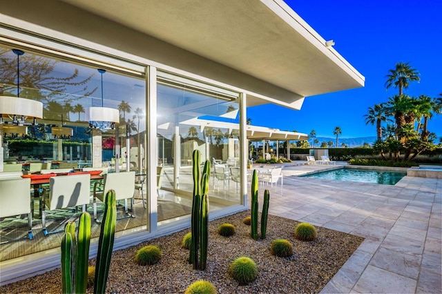 view of swimming pool with a patio