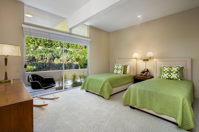 carpeted bedroom featuring beamed ceiling and floor to ceiling windows