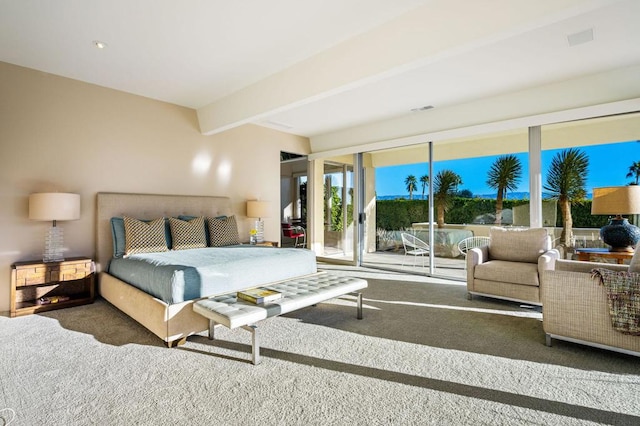 carpeted bedroom with beam ceiling and access to outside