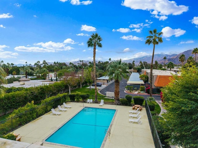 view of pool with a patio and a mountain view