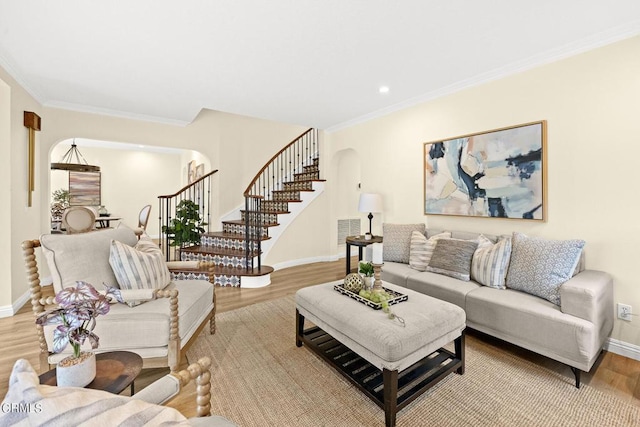 living room featuring ornamental molding and light hardwood / wood-style floors