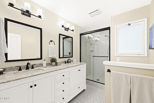 bathroom featuring walk in shower, vanity, and tile patterned flooring