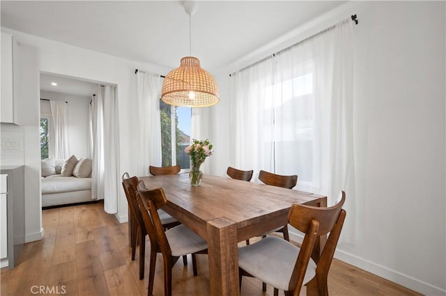 dining space with light hardwood / wood-style floors