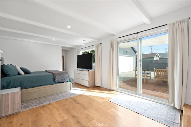 unfurnished bedroom featuring beam ceiling, light hardwood / wood-style flooring, and access to outside