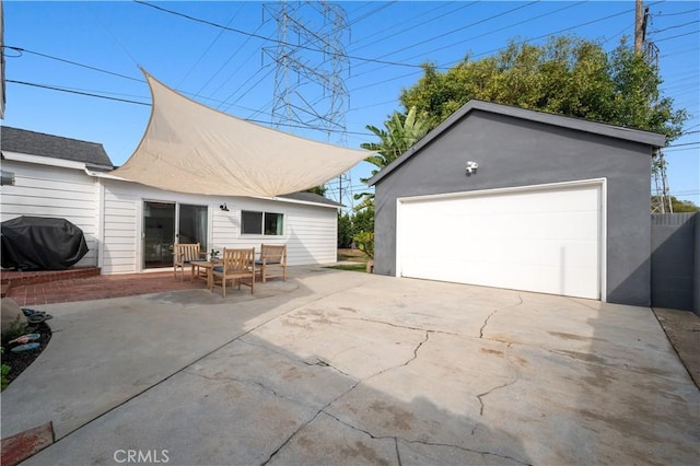 exterior space with a garage, a patio, and an outdoor structure