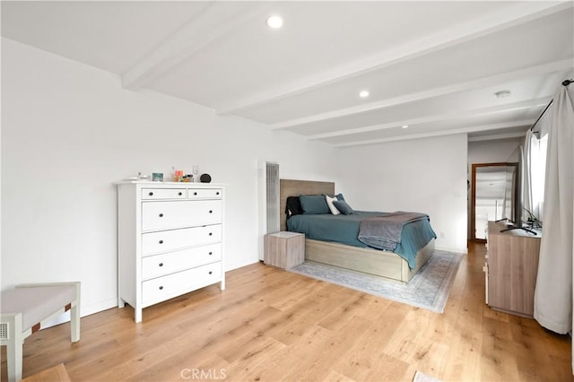 bedroom featuring beamed ceiling and light hardwood / wood-style floors