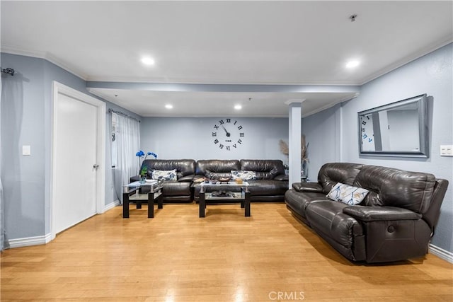 living room with ornamental molding and light hardwood / wood-style flooring