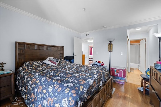 bedroom with hardwood / wood-style flooring and crown molding