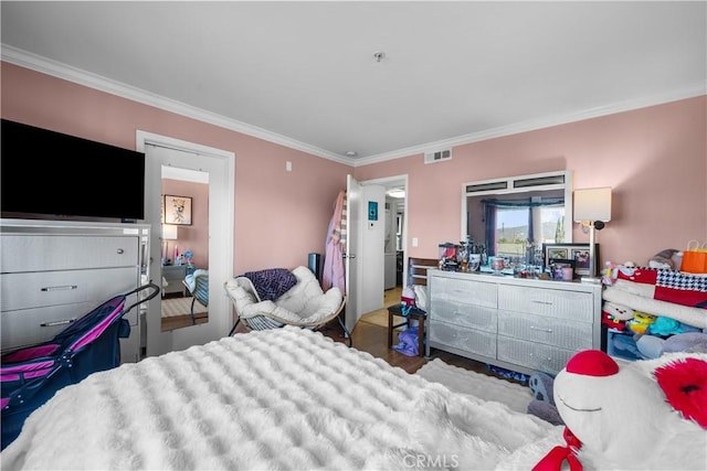 bedroom with hardwood / wood-style floors and crown molding