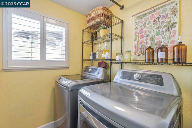 clothes washing area featuring separate washer and dryer